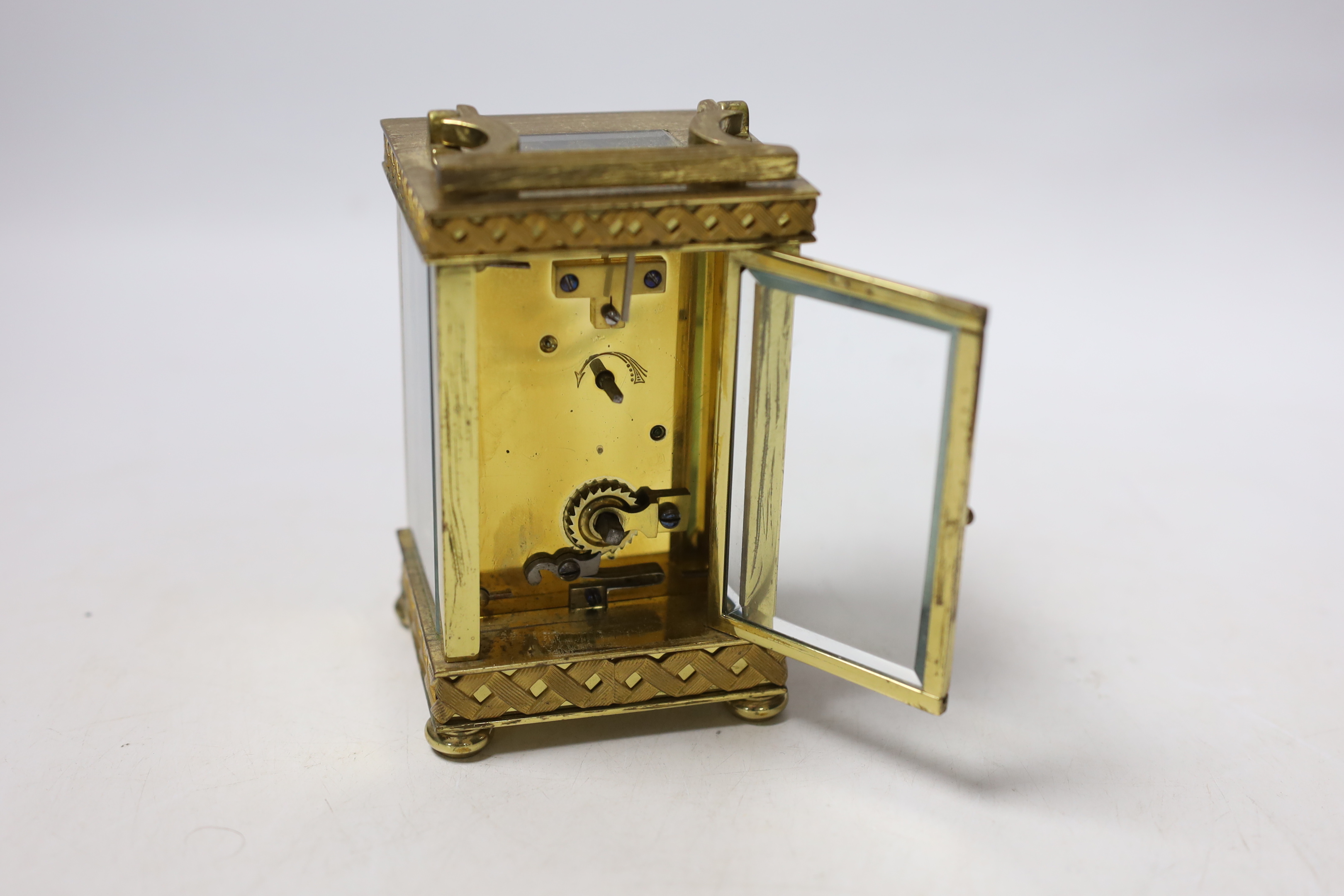 An Edwardian blind fretwork brass carriage timepiece, 12cm, in cloth covered case